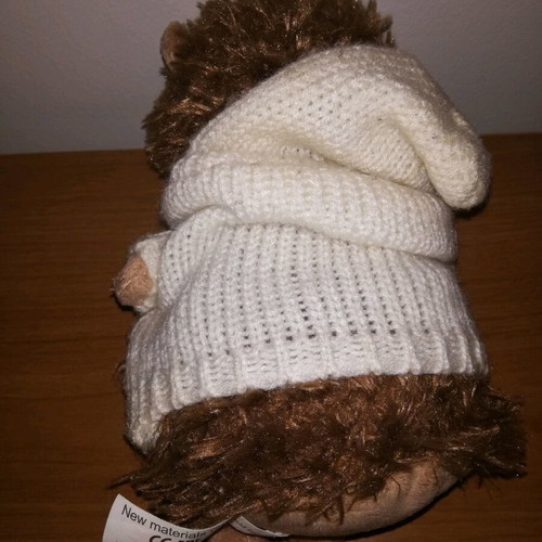 Plush hedgehog used with white knitted jacket