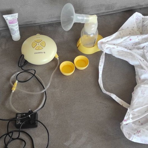 Mendela Swing breast pump used with nursing cover