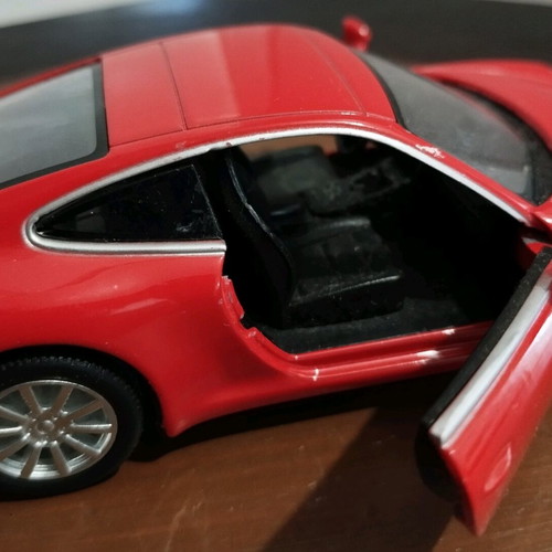 Collectible Porsche Carrera toy car with opening doors like new
