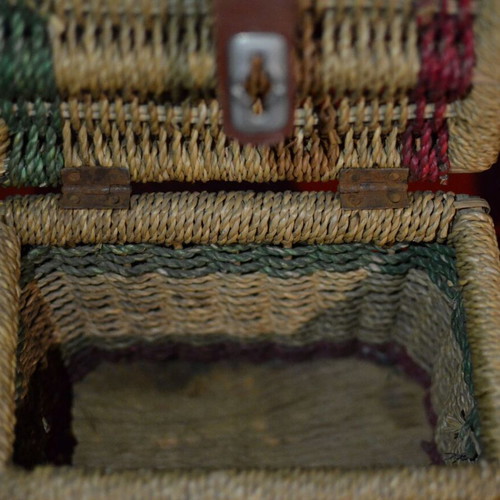 Vintage wicker storage basket used with leather strap and metal clasp