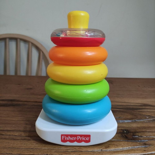 Fisher-Price stacking pyramid like new, 5 colorful rings with rattle base
