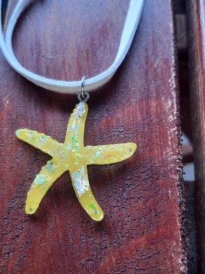 Handmade starfish pendant necklace with white cord, yellow iridescent