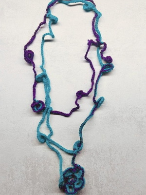 Handmade knitted necklace with flower, petrol and fuchsia