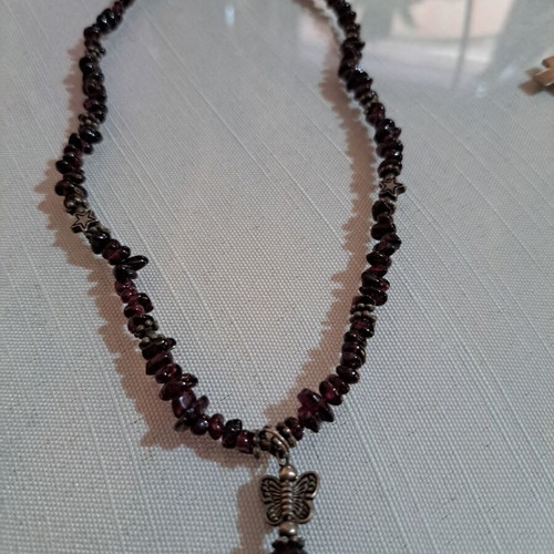 Necklace with purple beads and metallic butterfly and star charms
