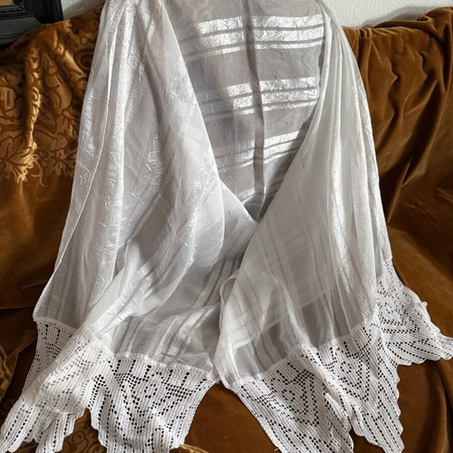 Large white table linen used with lace