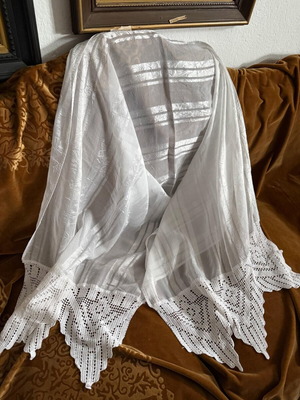 Large white table linen used with lace