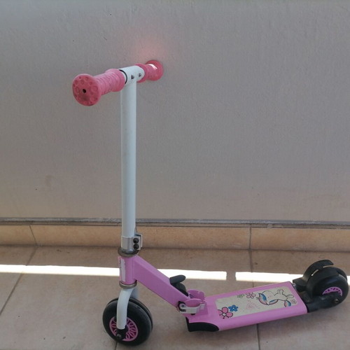 Pink children's scooter used with wear but fully functional
