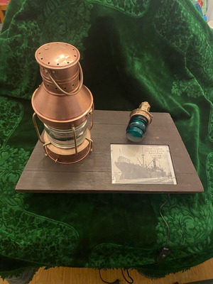 Nautical lantern and green navigation signal used on wooden stand