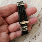 Black leather-type bracelet with silver elements used