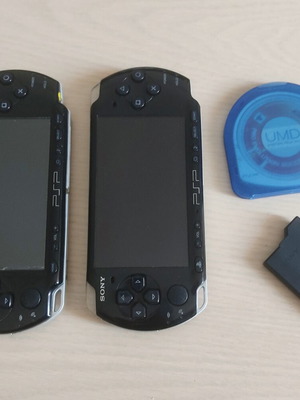 Sony PlayStation Portable PSP 2004 and 3004 consoles with game and battery