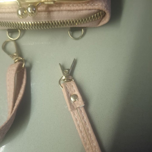 Pink wallet with strap and multiple compartments
