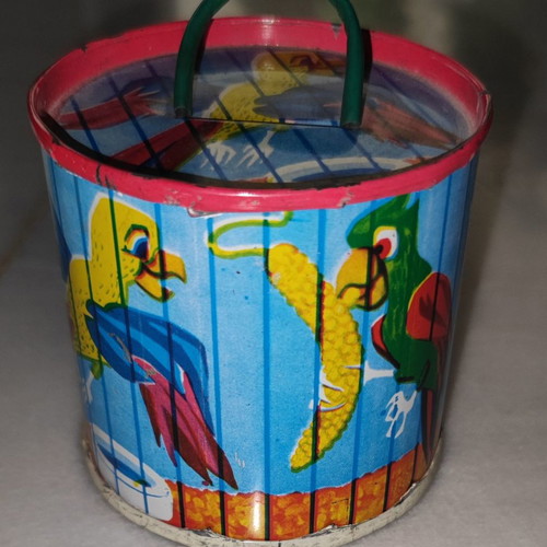 Vintage tin piggy bank used with parrots