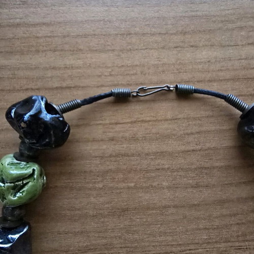 Necklace used with embossed large beads in black and green