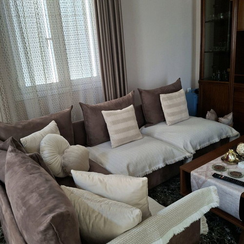 Corner sofa four-seater used, brown without covers and beige cushions
