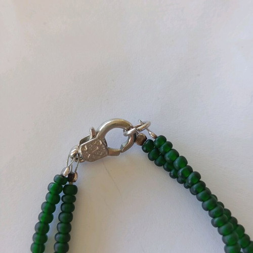 Handmade bracelet with green beads and silver umbrella charm