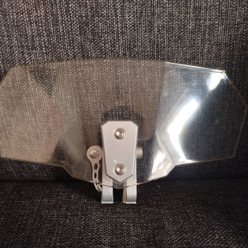 Adjustable windshield extension used, transparent