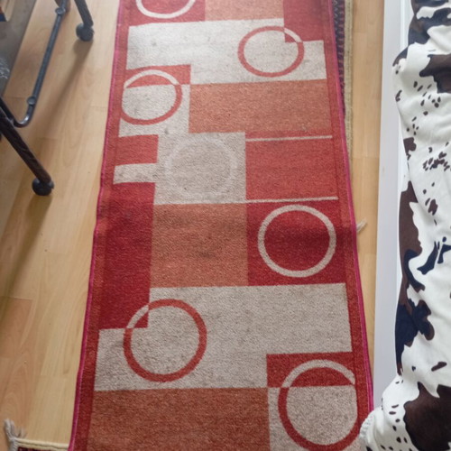 Vintage carpet runner used with geometric motifs in warm colors