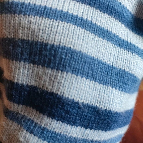 Knitted striped kids hat used, blue and turquoise