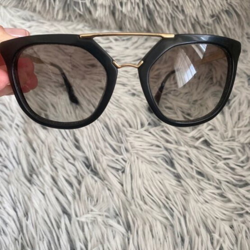 Prada sunglasses in black with gold details
