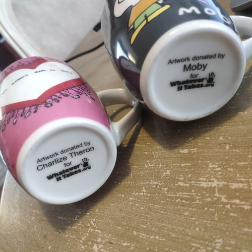Two collectible mugs like new, featuring Moby and Charlize Theron design