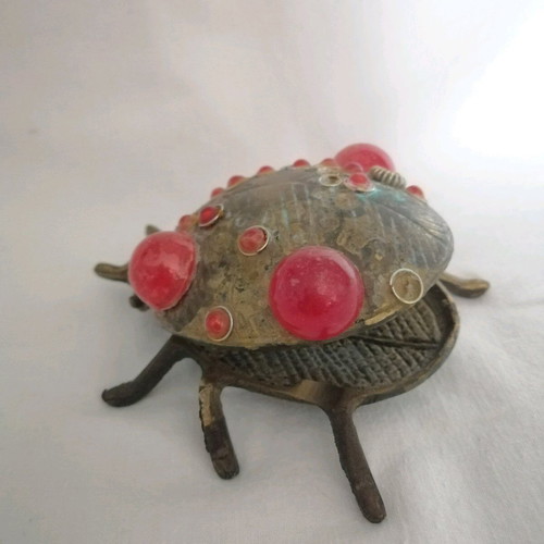 Bronze ashtray used with red scarab-shaped stones