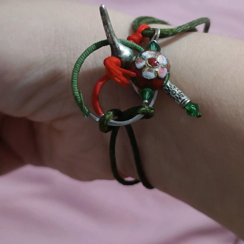 Bracelet new with various charms on green cord