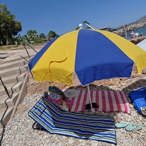 Beach umbrella used with carrying case and sand anchor