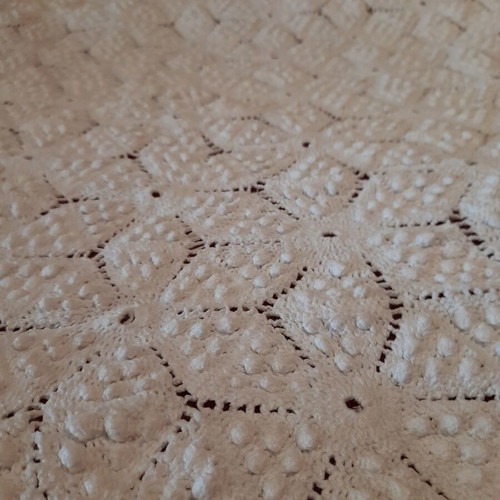 Handmade white crochet blanket in vintage style