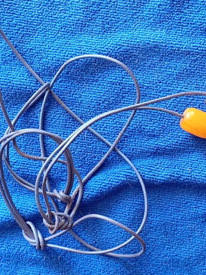 Begleri with boho pendant like new, orange beads on leather cord