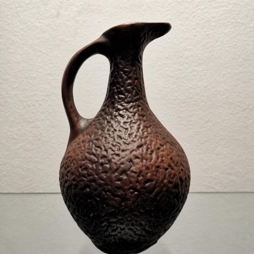 Clay jug used with embossed designs and grape cluster