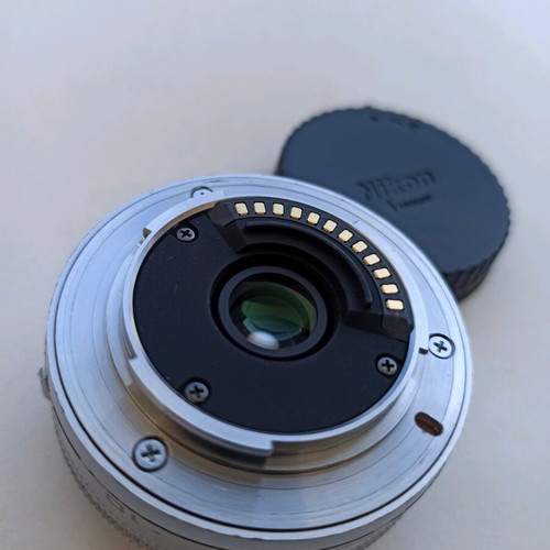 Nikon 1 NIKKOR 10mm f/2.8 lens used, silver compact prime