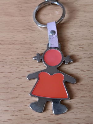 Metal keychain used with girl figure in red and silver