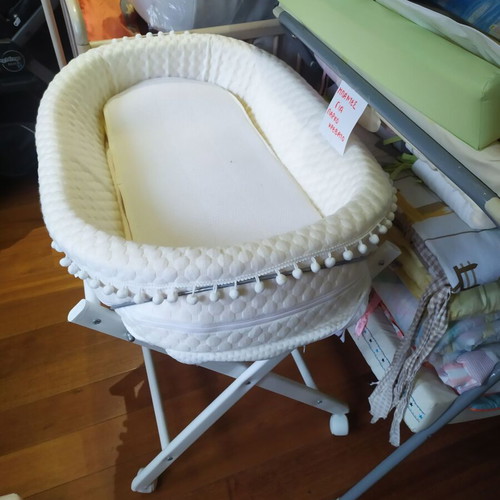 Bassinet on wooden base with wheels like new
