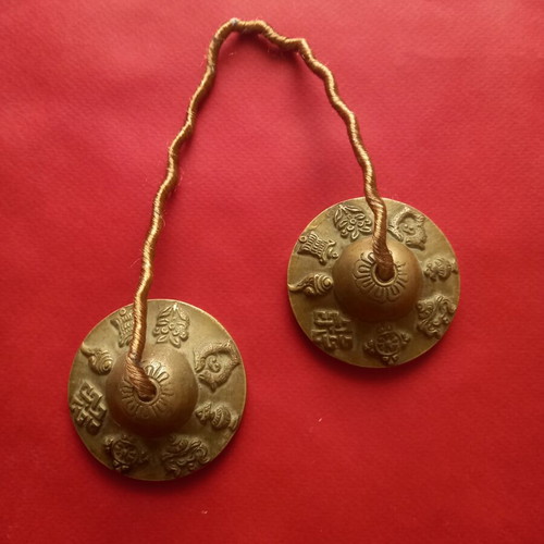 Tibetan cymbals used, known as Tingsha