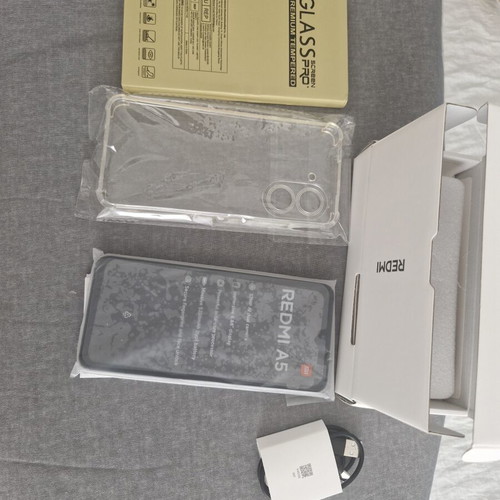 Redmi A5 64GB Sandy Gold smartphone with bonus glass protectors and case