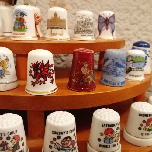 Porcelain thimbles like new, set of 33 with wooden base