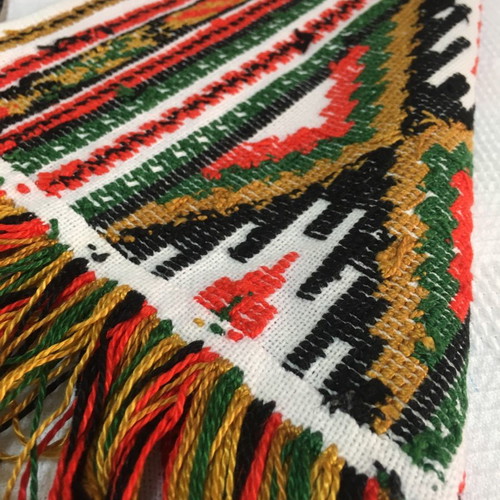 Set of handmade cross-stitch table runners with geometric patterns