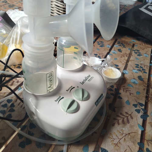Ameda Double Breast Pump like new with 3 bottles and milk storage bags