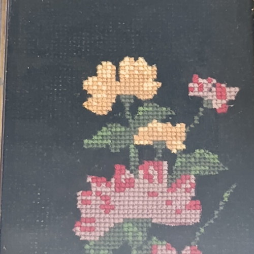 Vintage handmade embroidered textile painting in frame with glass