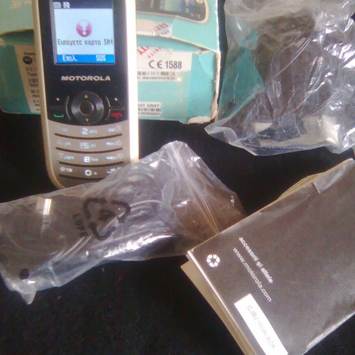 Motorola WX181 like new mobile phone with charger, headphones, and box