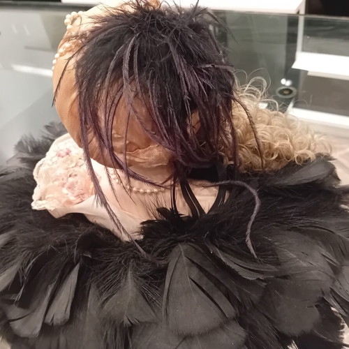 Vintage porcelain doll with feathers, handpainted, used