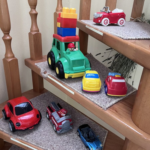 Toy cars, some unused, plastic and metal Mini Cooper