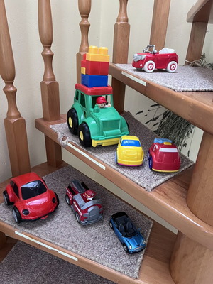 Toy cars, some unused, plastic and metal Mini Cooper