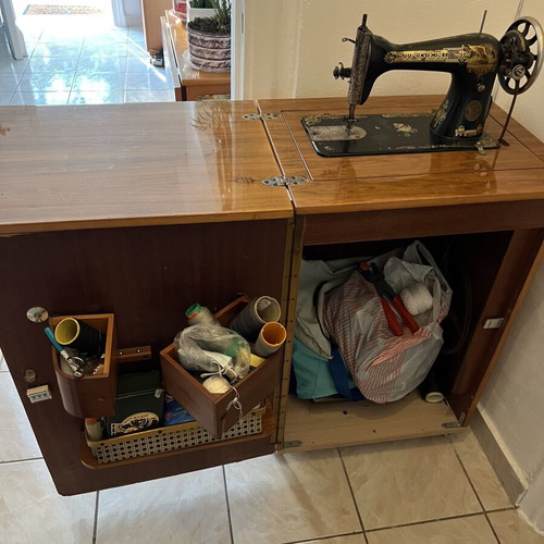 Singer sewing machine used with decorative cabinet