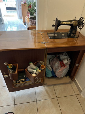 Singer sewing machine used with decorative cabinet