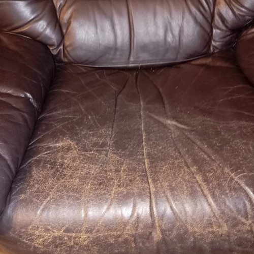 Leather recliner armchair used with wear on seat and footrest