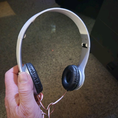 Foldable on-ear headphones used, white with silver details
