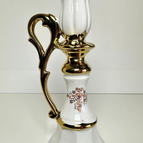 Ceramic candlestick with gold details and floral cross design