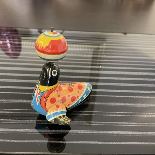 Seal with spinning ball vintage tin toy used