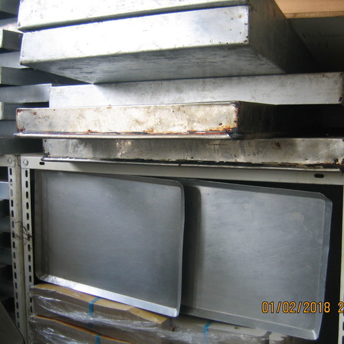 Stainless steel baking trays and serving pans used for cooking